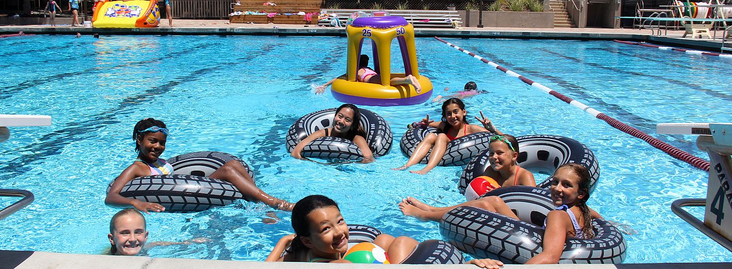 Kids float in inner tubes in the pool during Camp Carondelet in summer 2021.